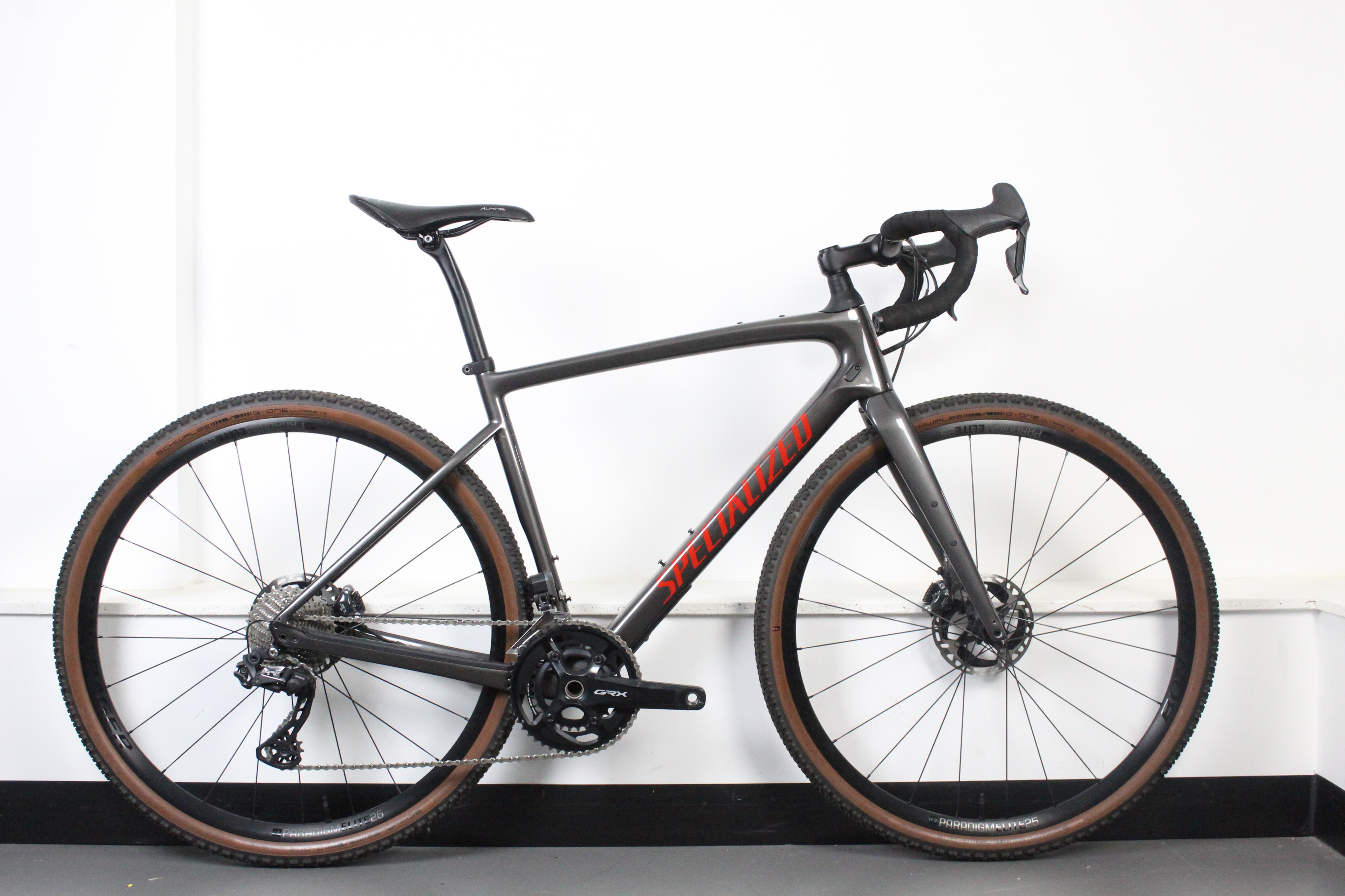 Gray bicycle with red branding on a white background
